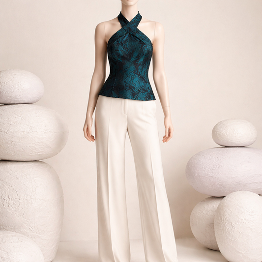 Sleeveless top by Muse is defined by its dramatic criss-cross halter neckline and structured silhouette. Size 16